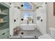 Bathroom showcasing a frameless shower, soaking tub, large window, and gray-toned hexagon tile flooring at 12 Trachelle Ln, Charleston, SC 29407