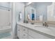 Well-lit bathroom featuring a double vanity, large mirror, and a shower-tub combination at 12 Trachelle Ln, Charleston, SC 29407