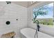 Bathroom featuring a soaking tub, matte black hardware, and an amazing marsh view at 12 Trachelle Ln, Charleston, SC 29407