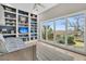 Bright bedroom with a wall of built-in bookshelves, a daybed, and large windows offering scenic views at 12 Trachelle Ln, Charleston, SC 29407