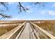 A long, wooden boardwalk extends into a picturesque marshland setting at 12 Trachelle Ln, Charleston, SC 29407