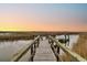 Peaceful view of the marsh from the boardwalk featuring sunset colors at 12 Trachelle Ln, Charleston, SC 29407