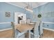 Comfortable dining room with light blue walls and doorway to bright white kitchen at 12 Trachelle Ln, Charleston, SC 29407