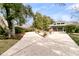 Spacious driveway showcases a home with mature trees, landscaping, and a multi-car garage at 12 Trachelle Ln, Charleston, SC 29407