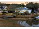Picturesque waterfront house with a private pier, solar panels, and well-maintained grounds for outdoor enjoyment at 12 Trachelle Ln, Charleston, SC 29407