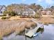Lovely waterfront home featuring a private dock, landscaped garden, and inviting ambiance at 12 Trachelle Ln, Charleston, SC 29407