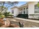 Inviting front entrance with a blue door, black stairs and railing, and bench in the front yard at 12 Trachelle Ln, Charleston, SC 29407
