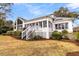 Quaint home with a beautiful yard, inviting stairs, and bright windows at 12 Trachelle Ln, Charleston, SC 29407