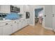 Charming kitchen with white cabinets, tiled backsplash, and stainless steel appliances at 12 Trachelle Ln, Charleston, SC 29407