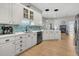 Stylish kitchen features white cabinetry, stainless steel appliances, and modern lighting fixtures at 12 Trachelle Ln, Charleston, SC 29407