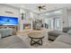 Comfortable living room with cozy fireplace, TV, wood floors and sliding glass doors to patio at 12 Trachelle Ln, Charleston, SC 29407