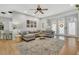 Bright living room featuring hardwood floors, comfortable seating arrangement, fireplace, and large windows at 12 Trachelle Ln, Charleston, SC 29407