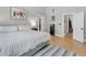 Bright bedroom featuring a light blue striped rug, en suite, and walk-in closet at 12 Trachelle Ln, Charleston, SC 29407