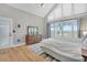 Bright bedroom featuring a large window with stunning marsh views and a light blue striped area rug at 12 Trachelle Ln, Charleston, SC 29407