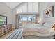 Bright main bedroom featuring large windows with beautiful marsh views and light wood flooring at 12 Trachelle Ln, Charleston, SC 29407