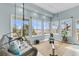 Bright sun room features a hanging chair, exercise equipment, and scenic views through large windows at 12 Trachelle Ln, Charleston, SC 29407