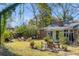 Lush backyard with mature trees, fire pit, and inviting seating arrangements at 1228 Penny Cir, Mount Pleasant, SC 29464