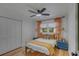 Comfortable bedroom showcasing natural light, ceiling fan, wood floors and blue bedside tables at 1228 Penny Cir, Mount Pleasant, SC 29464