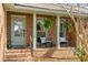 Inviting front porch featuring brick detail, seating, and hanging plants creating a welcoming entrance at 1228 Penny Cir, Mount Pleasant, SC 29464