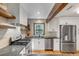 Contemporary kitchen featuring stainless steel appliances, white cabinetry, granite counters, and wood beams at 1228 Penny Cir, Mount Pleasant, SC 29464