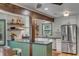 Charming kitchen featuring stainless appliances, white cabinets, granite countertops and unique wooden support beams at 1228 Penny Cir, Mount Pleasant, SC 29464