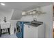 Well-organized laundry room featuring modern washer and dryer, utility sink and open shelf storage at 1228 Penny Cir, Mount Pleasant, SC 29464