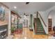 Open-concept living space with hardwood floors, fireplace, and seamless transition to kitchen and staircase at 1228 Penny Cir, Mount Pleasant, SC 29464