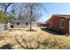 Spacious backyard view showcasing a detached garage, bare trees, lush grass, and a serene, private setting at 1258 Redeemer Dr, Hanahan, SC 29410
