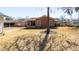 Backyard featuring a brick house, screened-in porch, sparse lawn, and mature trees providing shade and privacy at 1258 Redeemer Dr, Hanahan, SC 29410