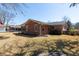 Expansive backyard view with a brick home, bare trees, lush grass, and a serene, private outdoor space at 1258 Redeemer Dr, Hanahan, SC 29410