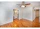 Bedroom featuring hardwood floors, ceiling fan, and a view into the bright en suite bathroom at 1258 Redeemer Dr, Hanahan, SC 29410