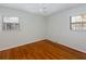 Bright bedroom featuring hardwood floors, two windows, and neutral wall color at 1258 Redeemer Dr, Hanahan, SC 29410