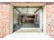 Spacious garage with a red brick exterior, neutral walls, and an open door allowing access to the interior at 1258 Redeemer Dr, Hanahan, SC 29410