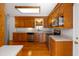 Traditional-style kitchen with wooden cabinets, stainless appliances, and a bright, windowed sink area at 1258 Redeemer Dr, Hanahan, SC 29410
