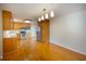 An open kitchen and dining area with wood cabinets, stainless appliances, and hardwood floors at 1258 Redeemer Dr, Hanahan, SC 29410