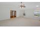 Inviting living room with vaulted ceilings, neutral carpet, and view into hallway and bathroom at 1258 Redeemer Dr, Hanahan, SC 29410