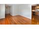 Living room with hardwood floors, white walls, and view into the kitchen at 1258 Redeemer Dr, Hanahan, SC 29410