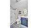 Bright bathroom with shower, modern vanity, round mirror, and gray flooring at 126 Moon Shadow Ln, Summerville, SC 29485