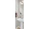 Elegant powder room featuring a pedestal sink, round mirror, and decorative accents at 126 Moon Shadow Ln, Summerville, SC 29485