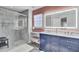 Bright bathroom features a blue vanity with marble countertops and a glass-enclosed shower at 126 Moon Shadow Ln, Summerville, SC 29485