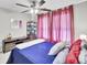 Bright bedroom featuring a ceiling fan, pink curtains and nautical decorations at 126 Moon Shadow Ln, Summerville, SC 29485