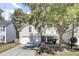 Charming two-story home featuring a well-manicured lawn and a large shade tree overhanging the front yard at 126 Moon Shadow Ln, Summerville, SC 29485