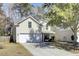 Two-story home featuring a front-facing garage, a manicured lawn, and a cozy front porch at 126 Moon Shadow Ln, Summerville, SC 29485