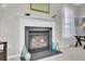 Bright living area shows a fireplace with a white mantle and black tile with decorations on and around it at 126 Moon Shadow Ln, Summerville, SC 29485