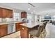 Well-lit kitchen features stainless steel appliances, cherry cabinets, and an island with seating at 126 Moon Shadow Ln, Summerville, SC 29485