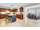 Bright eat-in kitchen boasts cherry cabinets, stainless appliances, an island with seating, and tile floors at 126 Moon Shadow Ln, Summerville, SC 29485