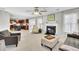 Open living area with a decorative fireplace, plush carpet, and an open view of the kitchen area at 126 Moon Shadow Ln, Summerville, SC 29485