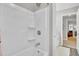 Shower and tub combo with integrated shelving, and a view to an adjoining room at 126 Moon Shadow Ln, Summerville, SC 29485