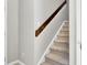 View of carpeted stairs with finished wood handrail in neutrally painted home at 126 Moon Shadow Ln, Summerville, SC 29485