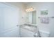 Bright bathroom with a marble vanity top, mirror and white door at 1300 Park West Blvd # 418, Mount Pleasant, SC 29466
